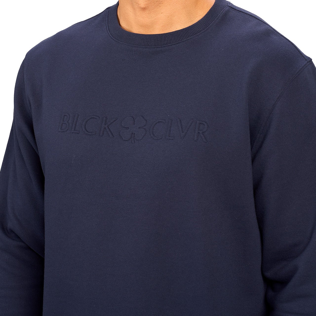 man wearing an navy colored sweater from Black Clover with a 3d text BLCK CLVR on the chest