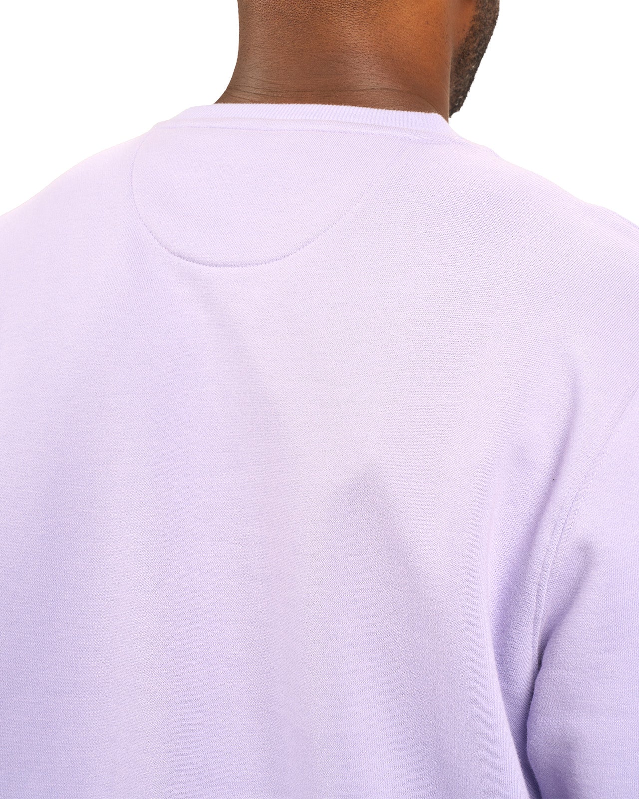 man wearing an light purple colored sweater from Black Clover with a 3d text BLCK CLVR on the chest